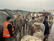 Army Maj. Gen. Eric Shirley, U.S. Army Sustainment Command’s commanding general, and Command Sgt. Maj. Jason Gusman, ASC’s senior enlisted advisor, speak to members from Army Field Support Battalion-Germany and the 405th Army Field Support Brigade at the Coleman Army Prepositioned Stocks-2 worksite In Mannheim, Germany, during their site visit to Europe, Dec. 9-12, 2025. (U.S. Army courtesy photo)