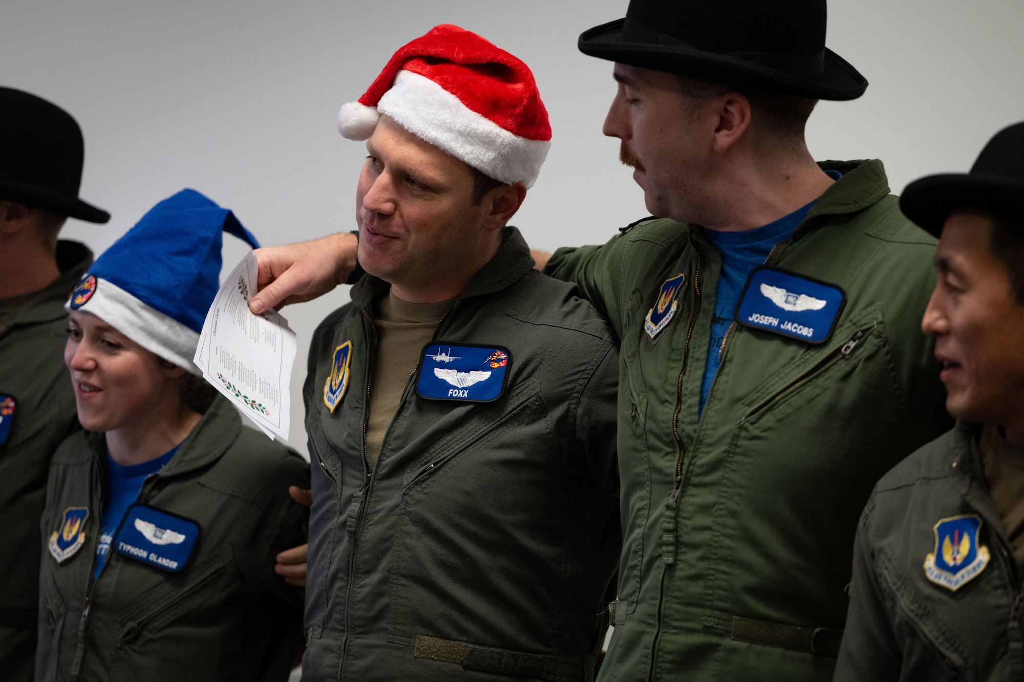Members of the 492nd Fighter Squadron sing Christmas carols at the Imperial War Museum Duxford, Cambridge, England.