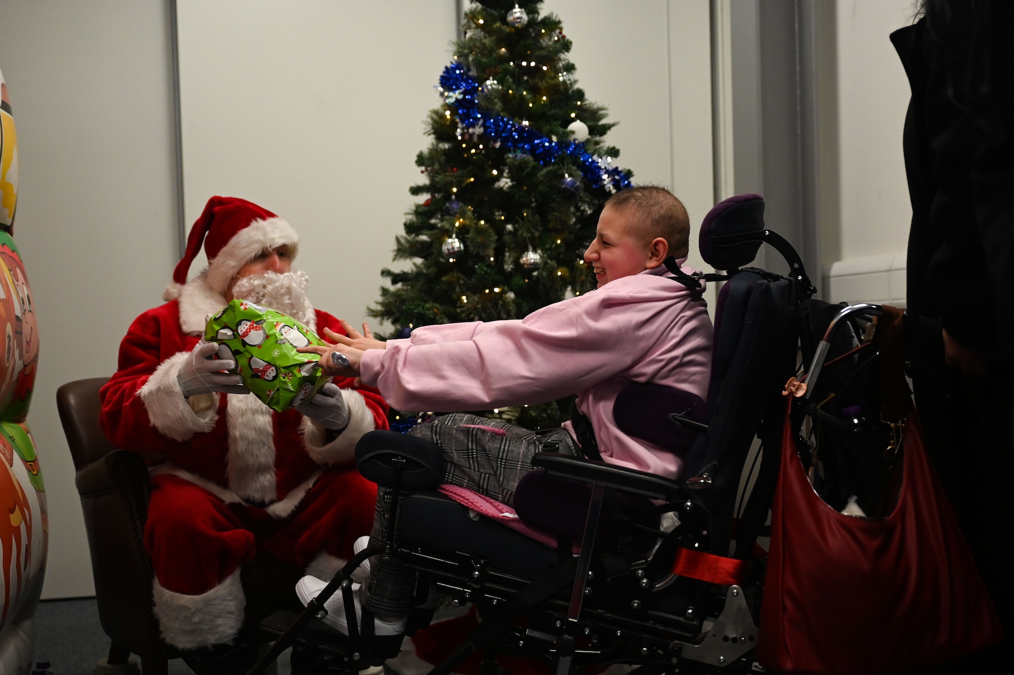 U.S. Air Force Lt. Col. David Bervig, 492nd Fighter Squadron commander, gives a gift to a child from the East Anglia Children’s Hospices at the Imperial War Museum Duxford, Cambridge, England.