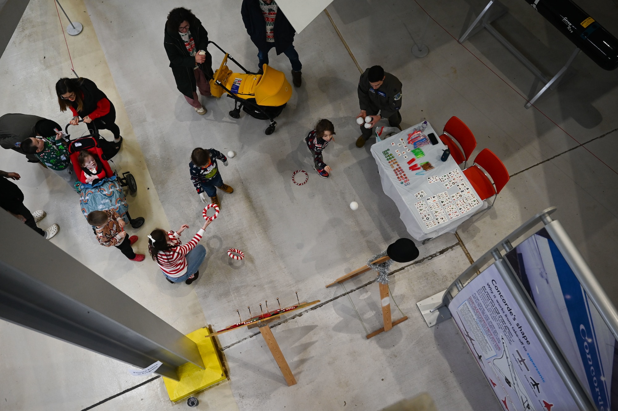 Members and volunteers from the 492nd Fighter Squadron play Christmas themed games with children from the East Anglia Children’s Hospices at the Imperial War Museum Duxford, Cambridge, England.