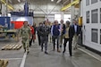 Kate Williams, Directorate of Strategic Management director, provides a mission and capabilities overview to Sen. Dave McCormick, Rep. John Joyce and staff members inside a maintenance facility during their visit to Letterkenny Army Depot, Dec. 6.