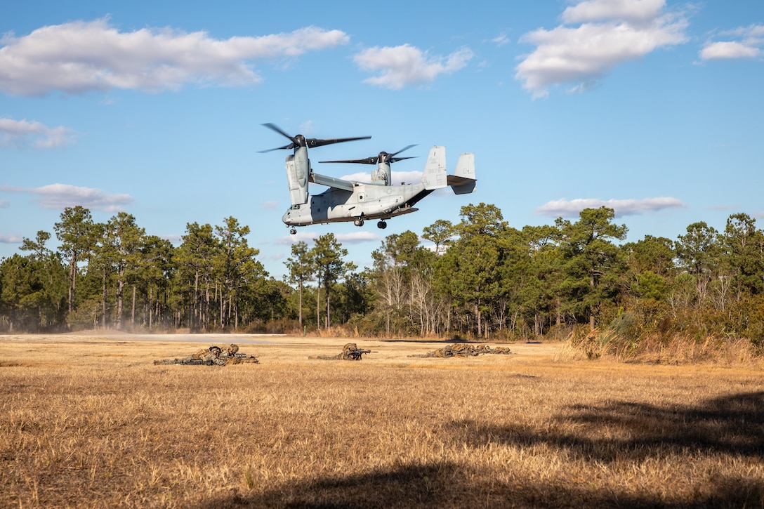 U.S. Marines and Sailors with the 3d Battalion, 2d Marines, 24th Marine Expeditionary Unit (MEU), hold security as an MV-22B Osprey, with Marine Medium Tilt Rotor Squadron 365 (Reinforced), departs the landing zone during insert/extract drills on Camp Lejeune, North Carolina, on December 11, 2025. The 24th MEU is a Marine Air Ground Task Force ready to answer the Nation’s call in any clime and place. (U.S. Marine Corps photo by Gunnery Sgt. Hector de Jesus)