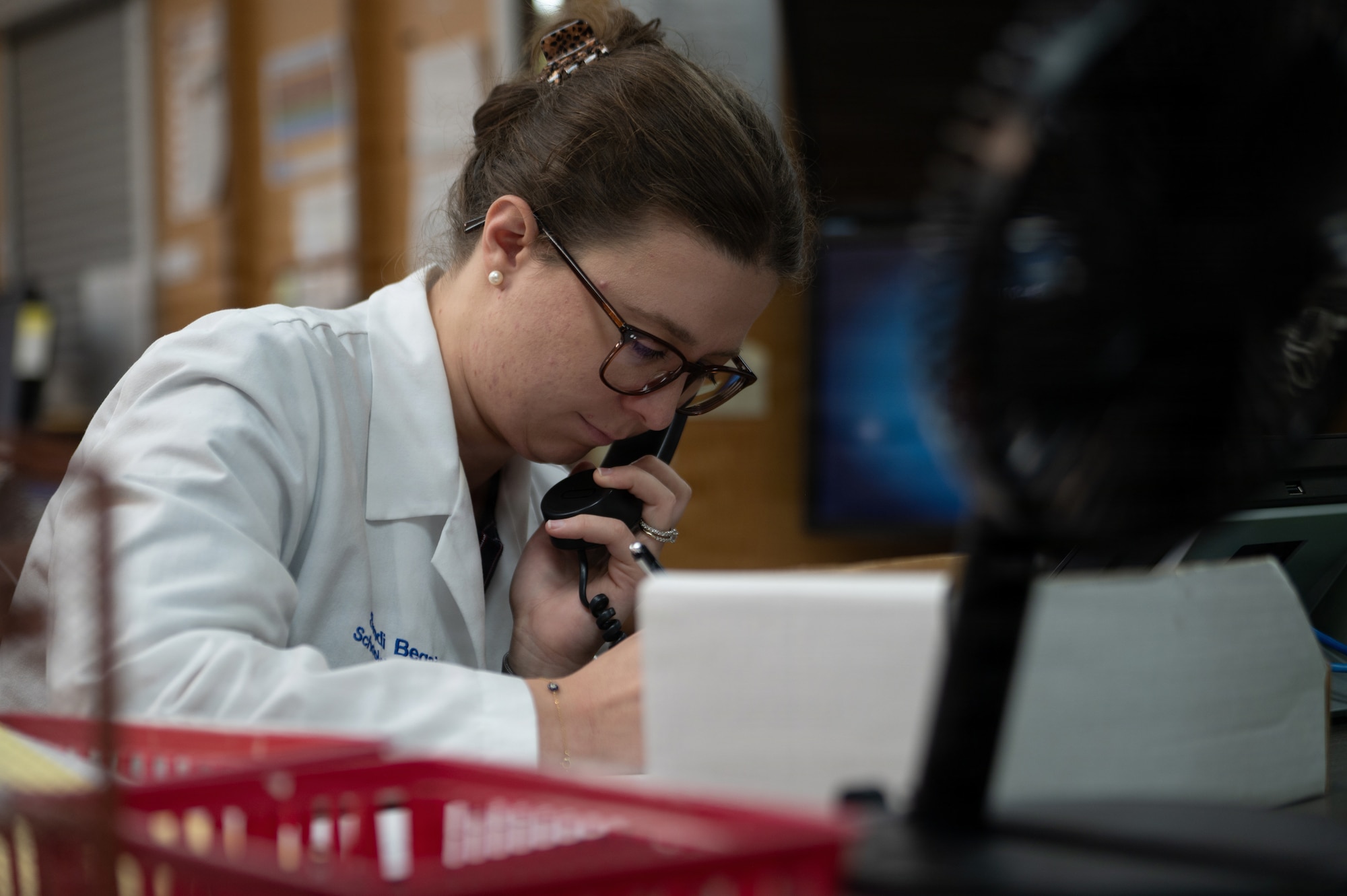 Sindi Begaj, pharmacy intern at Lake Erie College of Osteopathic Medicine School of Pharmacy, answers voicemails at MacDill Air Force Base, Florida, Oct. 20, 2025. The pharmacy promotes mission readiness and upholds the health of all wing personnel by providing necessary pharmaceutical care and services. (U.S. Air Force photo by Airman 1st Class Autumn Lindor)