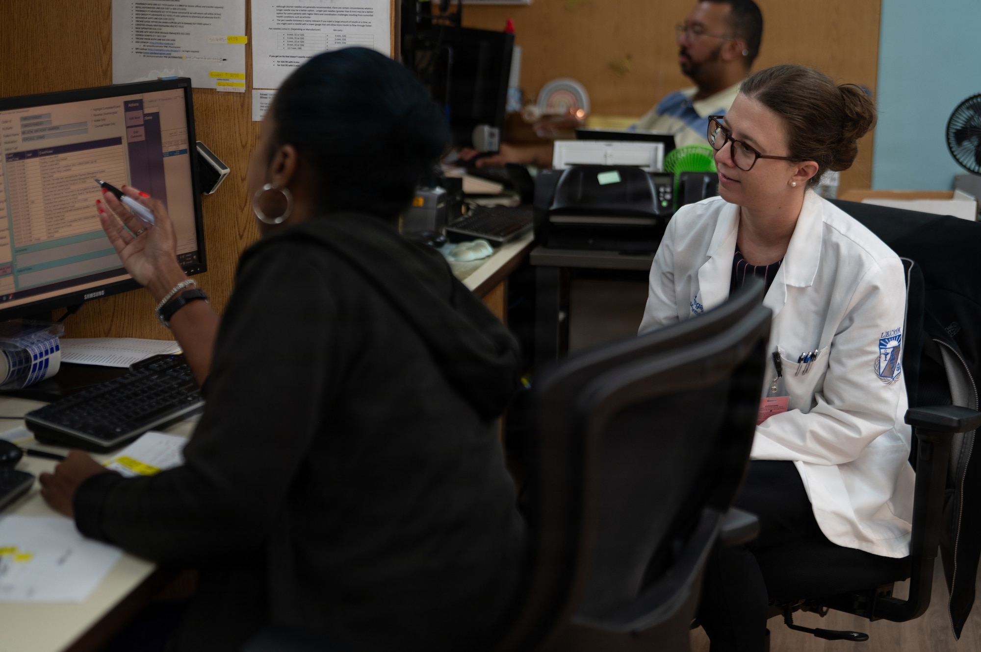 Kenzier McIntyre, 6th Medical Support Squadron pharmacist, left, trains Sindi Begaj, pharmacy intern at Lake Erie College of Osteopathic Medicine School of Pharmacy, at MacDill Air Force Base, Florida, Oct. 20, 2025. The pharmacy promotes mission readiness and upholds the health of all wing personnel by providing necessary pharmaceutical care and services. (U.S. Air Force photo by Airman 1st Class Autumn Lindor)
