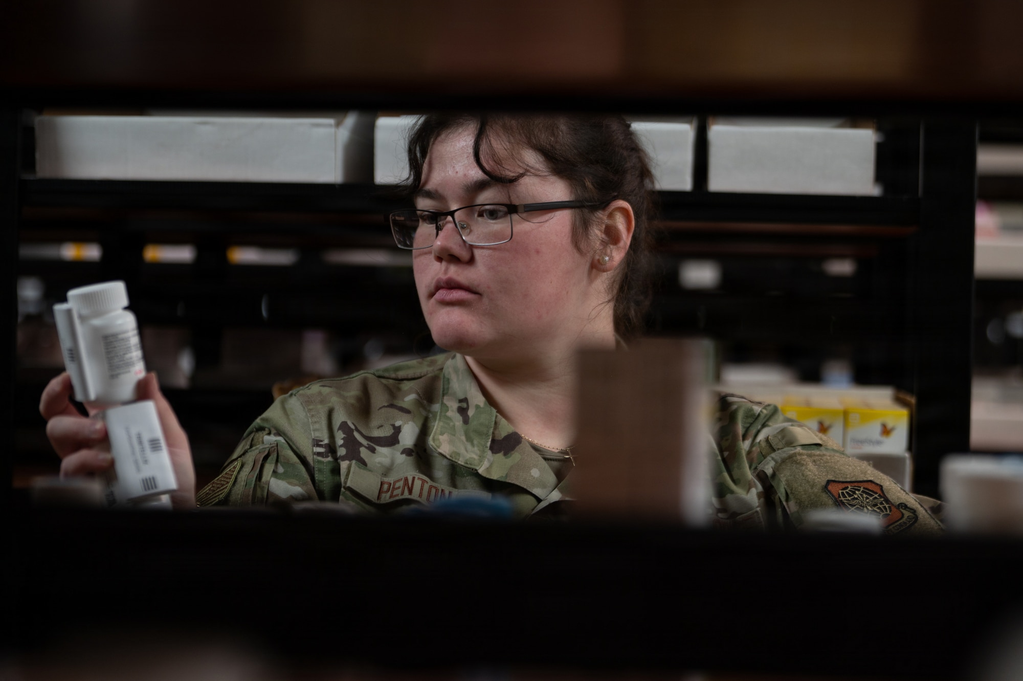 U.S. Air Force Airman 1st Class Jocelyn Penton, 6th Medical Support Squadron pharmacy technician, restocks medication at MacDill Air Force Base, Florida, Oct. 20, 2025. The pharmacy promotes mission readiness and upholds the health of all wing personnel by providing necessary pharmaceutical care and services. (U.S. Air Force photo by Airman 1st Class Autumn Lindor)
