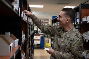 U.S. Air Force Airman 1st Class Lucas Crider, 6th Medical Support Squadron pharmacy technician, restocks medication at MacDill Air Force Base, Florida, Oct. 20, 2025. The pharmacy promotes mission readiness and upholds the health of all wing personnel by providing necessary pharmaceutical care and services. (U.S. Air Force photo by Airman 1st Class Autumn Lindor)