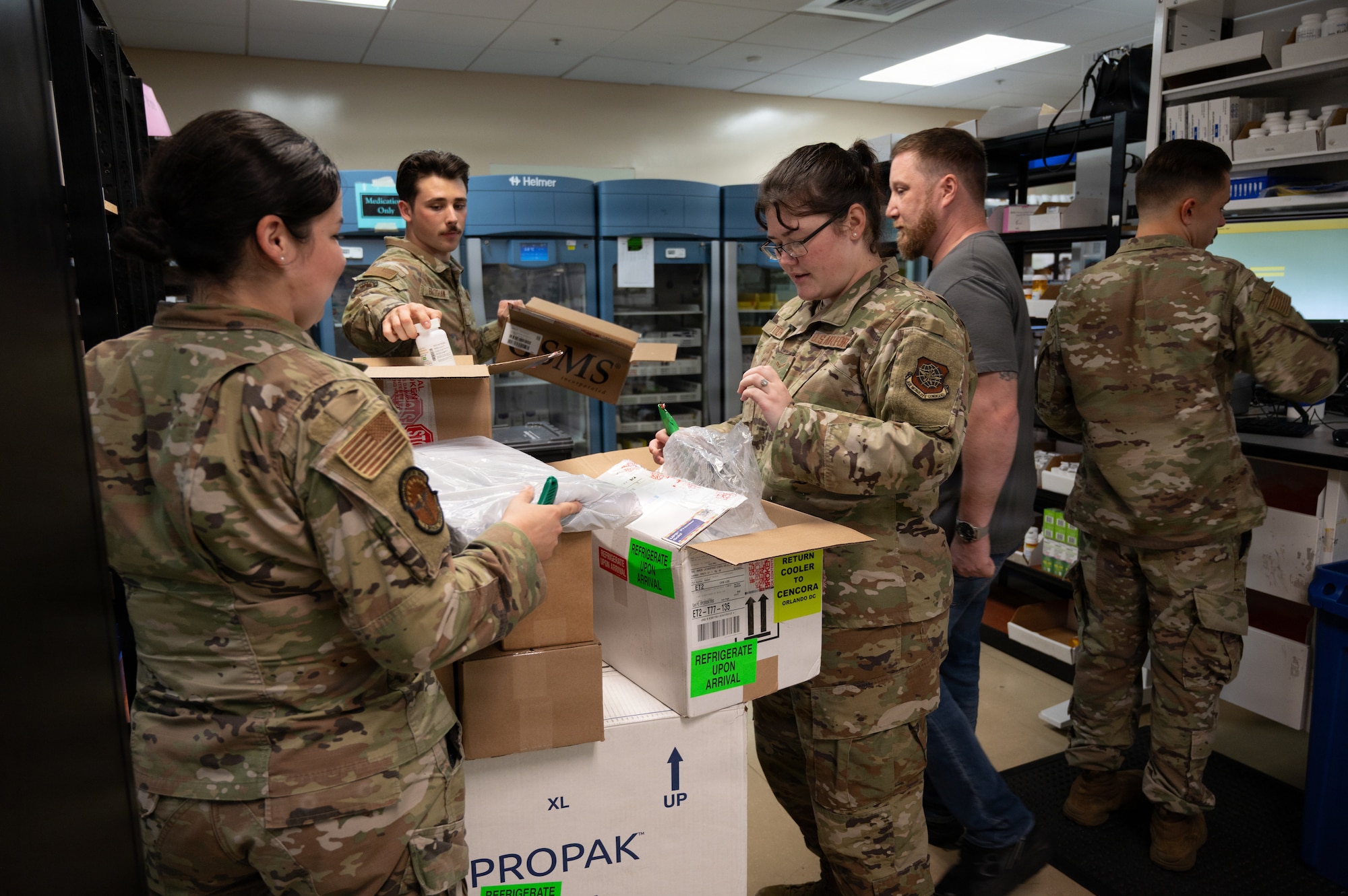 Pharmacy technicians assigned to the 6th Medical Support Squadron open boxes of medication at MacDill Air Force Base, Florida, Oct. 20, 2025. The pharmacy promotes mission readiness and upholds the health of all wing personnel by providing necessary pharmaceutical care and services. (U.S. Air Force photo by Airman 1st Class Autumn Lindor)