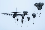 U.S. Army paratroopers assigned to the 2nd Infantry Brigade Combat Team (Airborne), 11th Airborne Division, “Arctic Angels,” jump from a U.S. Marine Corps Reserve KC-130J Hercules assigned to the Marine Aerial Refueler Transport Squadron 234 (VMGR-234), Naval Air Station Joint Reserve Base, Fort Worth, Texas, Naval Air Station Joint Reserve Base, Fort Worth, Texas, at Malemute Drop Zone, Joint Base Elmendorf-Richardson, Alaska, May 24, 2023, in honor of Spartan Memorial Week. Paratroopers carried the nametapes of 77 fallen paratroopers who made the ultimate sacrifice during deployments to Afghanistan and Iraq. Paratroopers then placed the name tapes on a memorial before gathered Gold Star family members and fellow Soldiers. (U.S. Air Force photo by Airman 1st Class Julia Lebens) (Airman 1st Class Julia Lebens)