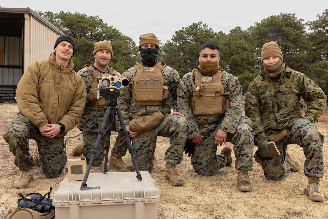 U.S. Marine Corps forward observers pose for a photo during a live-fire exercise at Joint Base McGuire-Dix-Lakehurst, New Jersey, Dec. 6, 2025. Forward observers, with 2nd Battalion, 25th Marine Regiment, 4th Marine Division, support live-fire drills with M252A2 81mm mortar systems to improve tactical decision-making, leadership and technical skills while maintaining readiness for future missions. (U.S. Marine Corps photo by Lance Cpl. Breysson Villacortacampos)