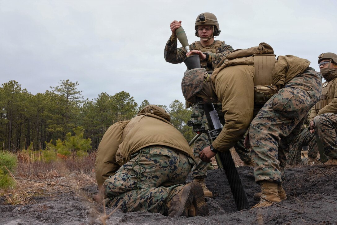 U.S. Marine Corps mortarmen fire high-explosive ammunition from an M252A2 81mm mortar during a live-fire exercise at Joint Base McGuire-Dix-Lakehurst, New Jersey, Dec. 6, 2025. The mortarmen, assigned to 2nd Battalion, 25th Marine Regiment, 4th Marine Division, conducts the drill to improve tactical decision-making, leadership and technical skills while ensuring readiness for future missions. (U.S. Marine Corps photo by Lance Cpl. Breysson Villacortacampos)