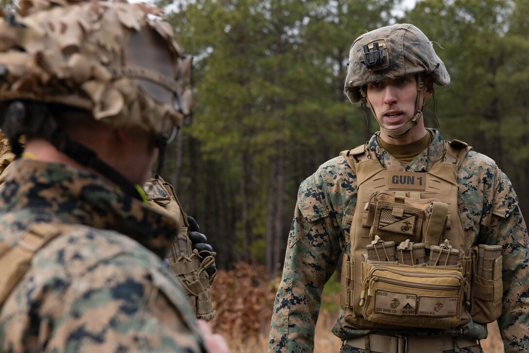 U.S. Marine Corps Lance Cpl. Matthew Brech, left, receives instructions from Sgt. Nicholas Fraker, right, at Joint Base McGuire-Dix-Lakehurst, New Jersey, Dec. 6, 2025. Brech and Fraker, mortarmen with 2nd Battalion, 25th Marine Regiment, 4th Marine Division, carry out live-fire drills with M252A2 81mm mortar systems to improve tactical decision-making, leadership and technical skills while ensuring readiness for future missions. (U.S. Marine Corps photo by Lance Cpl. Breysson Villacortacampos)