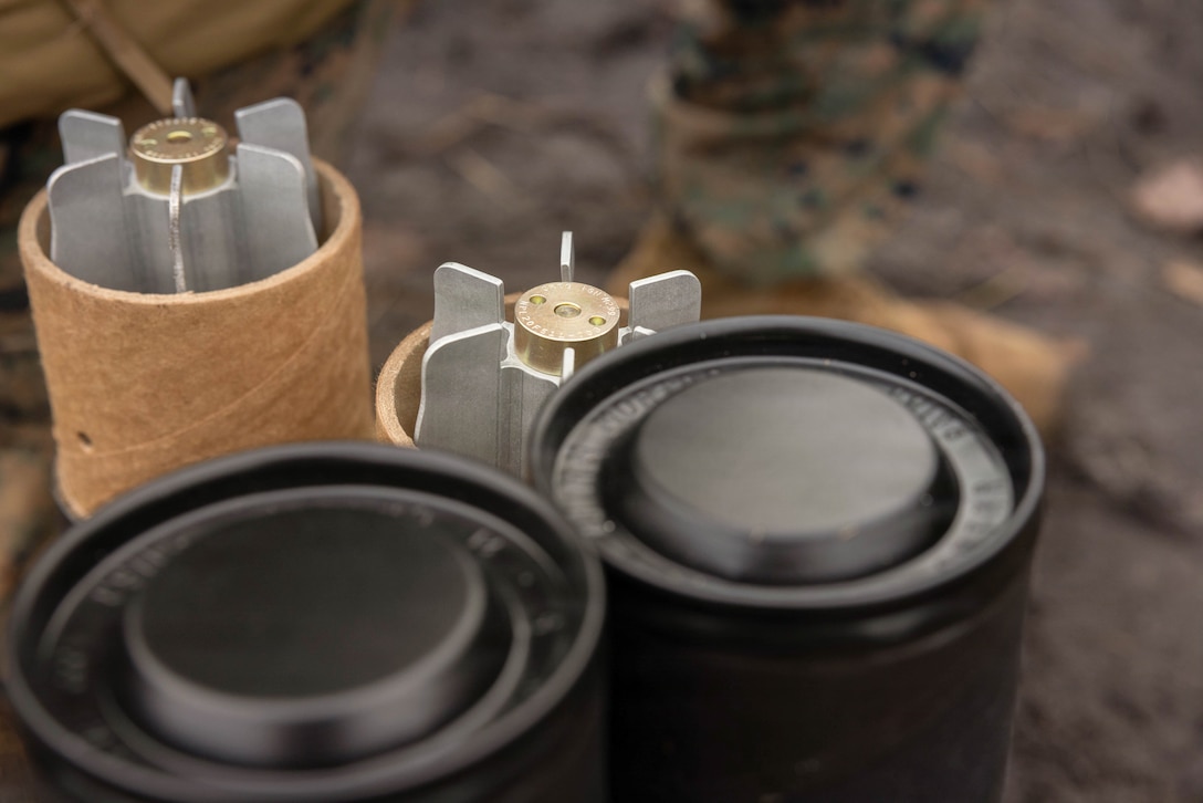 81mm practice rounds rest next to two closed containers during a live-fire exercise at Joint Base McGuire-Dix-Lakehurst, New Jersey, Dec. 6, 2025. The practice rounds used by Marines with 2nd Battalion, 25th Marine Regiment, 4th Marine Division, to improve Marines’ proficiency with the M252A2 81mm mortar system. (U.S. Marine Corps photo by Lance Cpl. Breysson Villacortacampos)