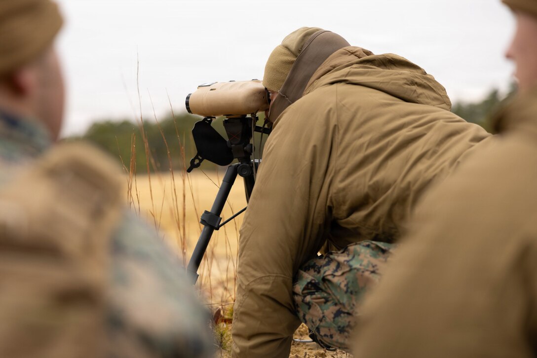 U.S. Marine Corps Pfc. Richard Chaple, a forward observer, looks through a Common Laser Range Finder–Integrated Capability (CLRF-IC) system at Joint Base McGuire-Dix-Lakehurst, New Jersey, Dec. 6, 2025. Chaple, with 2nd Battalion, 25th Marine Regiment, 4th Marine Division, supports live-fire drills with M252A2 81mm mortar systems to improve tactical decision-making, leadership and technical skills while maintaining readiness for future missions. (U.S. Marine Corps photo by Lance Cpl. Breysson Villacortacampos)