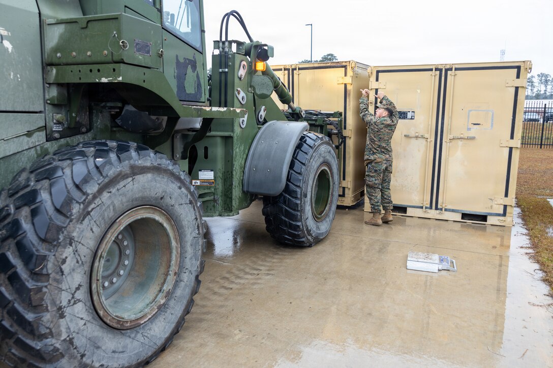 U.S. Marine Corps Lance Cpl. Ayana Mendez, a motor vehicle operator with II Marine Expeditionary Force Support Battalion, II MEF Information Group, guides a Tractor, Rubber-Tired, Articulated Steering, Multi-Purpose vehicle at Marine Corps Base Camp Lejeune North Carolina, Dec. 5, 2025. Marines with II MEF Support Battalion then loaded the equipment in preparation for missions, honing their skills while showcasing the unit’s capabilities to prepare for onward movement at a moment’s notice. (U.S. Marine Corps photo by Lance Cpl. Dorian Melrath)