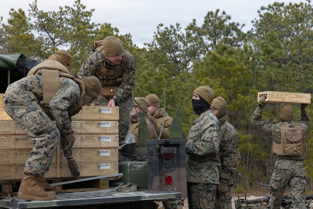 U.S. Marine Corps mortarmen off-load ammunition for M252A2 81mm mortar systems for a live-fire exercise at Joint Base McGuire-Dix-Lakehurst, New Jersey, Dec. 5, 2025. Marines with 2nd Battalion, 25th Marine Regiment, 4th Marine Division, conduct live-fire drills to prepare for future events, missions, and deployments while promoting tactical decision-making, leadership and technical skills. The exercise supports ongoing efforts to sustain combat readiness and reinforce core infantry skills across the battalion. (U.S. Marine Corps photo by Lance Cpl. Breysson Villacortacampos)