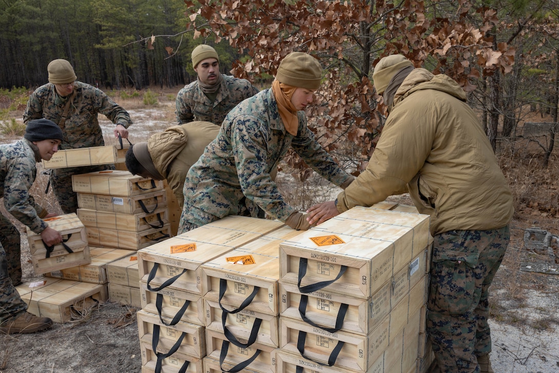 U.S. Marine Corps mortarmen stack ammunition for M252A2 80mm mortar systems for a live-fire exercise at Joint Base McGuire-Dix-Lakehurst, New Jersey, Dec. 5, 2025. Marines with 2nd Battalion, 25th Marine Regiment, 4th Marine Division, conduct live-fire drills to prepare for future events, missions, and deployments while promoting tactical decision-making, leadership and technical skills. The exercise supports ongoing efforts to sustain combat readiness and reinforce core infantry skills across the battalion. (U.S. Marine Corps photo by Lance Cpl. Breysson Villacortacampos)