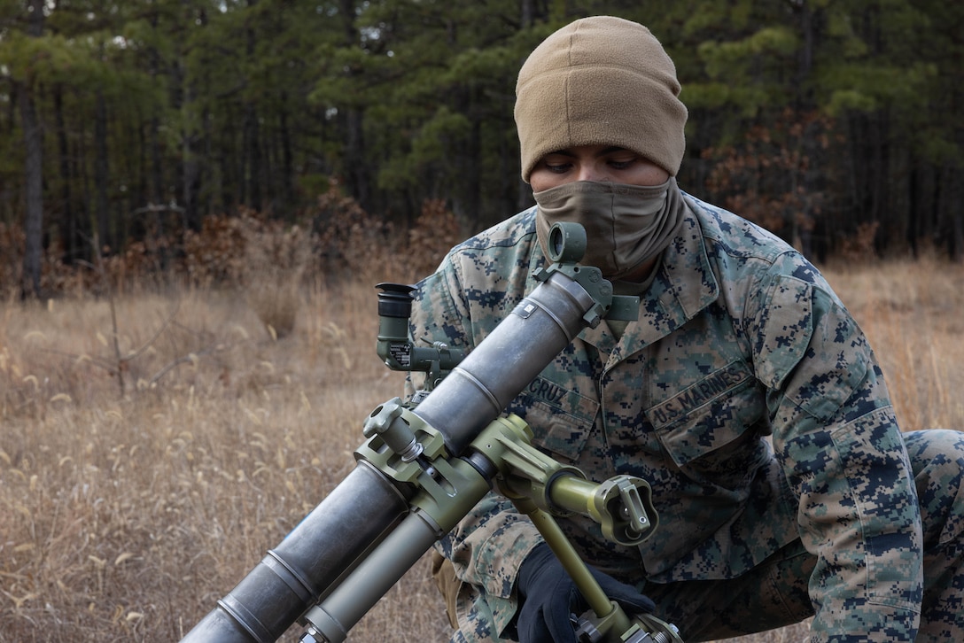 U.S. Marine Corps Pfc. Cruz Yhair, a mortarman, sights an M252A2 60 mm mortar system as he prepares for a live-fire exercise at Joint Base McGuire-Dix-Lakehurst, New Jersey, Dec. 5, 2025. Yhair, a Marine with 2nd Battalion, 25th Marine Regiment, 4th Marine Division, conducts live-fire drills to improve tactical decision-making, leadership, and technical skills during the training event. The exercise supports ongoing efforts to sustain combat readiness and reinforce core infantry skills across the battalion. (U.S. Marine Corps photo by Lance Cpl. Breysson Villacortacampos)