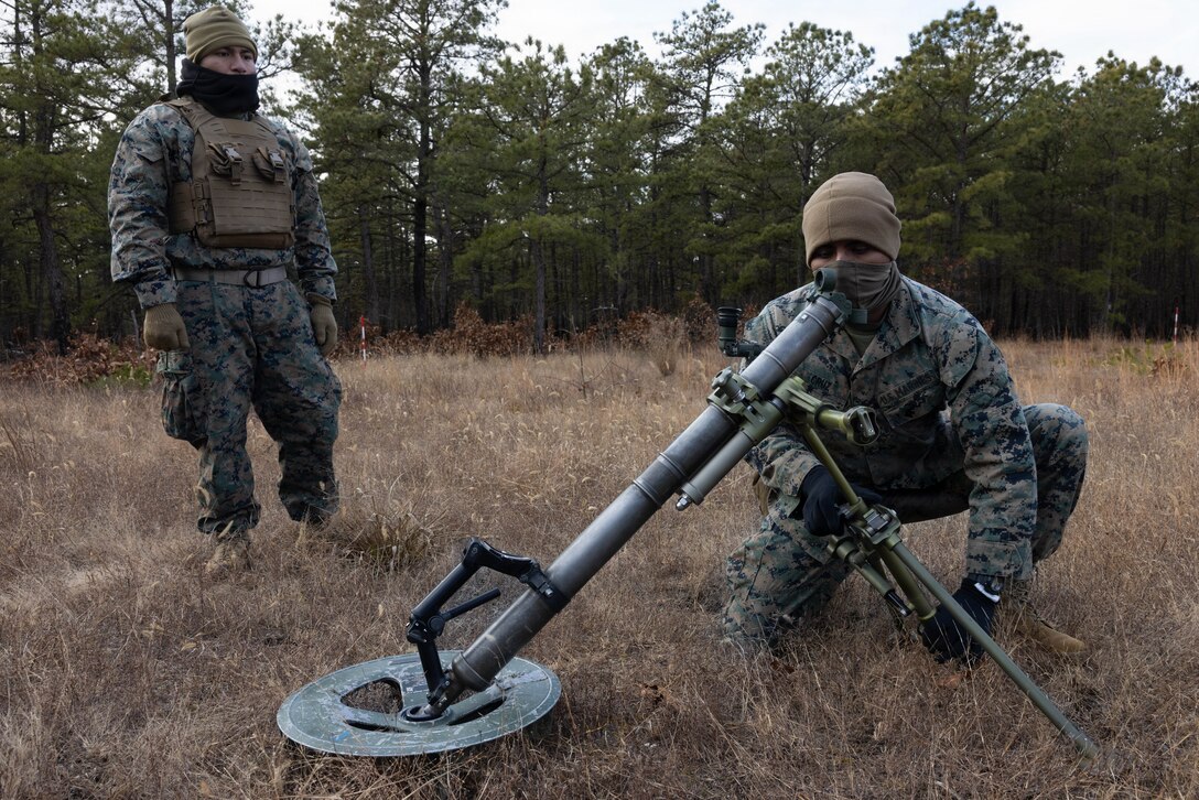 U.S. Marine Corps Pfc. Christoffer Herrera Meneses and Pfc. Cruz Yhair, both mortarmen, sights an M252A2 60mm mortar system as they prepare for a live-fire exercise at Joint Base McGuire-Dix-Lakehurst, New Jersey, Dec. 5, 2025. These Marines with 2nd Battalion, 25th Marine Regiment, 4th Marine Division conduct live-fire drills to improve tactical decision-making, leadership, and technical skills during the training event. The exercise supports ongoing efforts to sustain combat readiness and reinforce core infantry skills across the battalion. (U.S. Marine Corps photo by Lance Cpl. Breysson Villacortacampos)