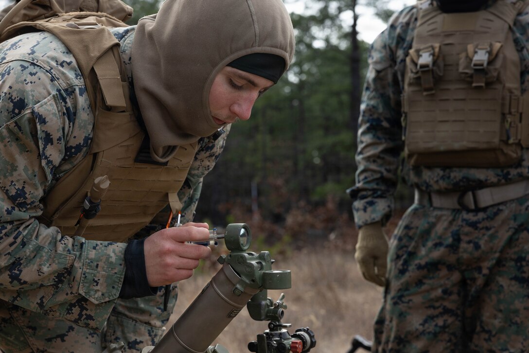 U.S. Marine Corps Lance Cpl. Samuel Tomlinson, a mortarman, turns the dials with a screwdriver on a M252A2 60mm mortar system as he prepares for a live-fire exercise at Joint Base McGuire-Dix-Lakehurst, New Jersey, Dec. 5, 2025. Tomlinson, a Marine with 2nd Battalion, 25th Marine Regiment, 4th Marine Division, conducts live-fire drills to enhance tactical decision-making, leadership, and technical proficiency during the training event. The exercise supports ongoing efforts to sustain combat readiness and reinforce core infantry skills across the battalion. (U.S. Marine Corps photo by Lance Cpl. Breysson Villacortacampos)