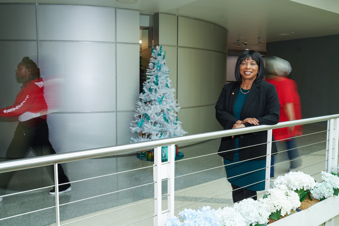 Woman standing at railing.