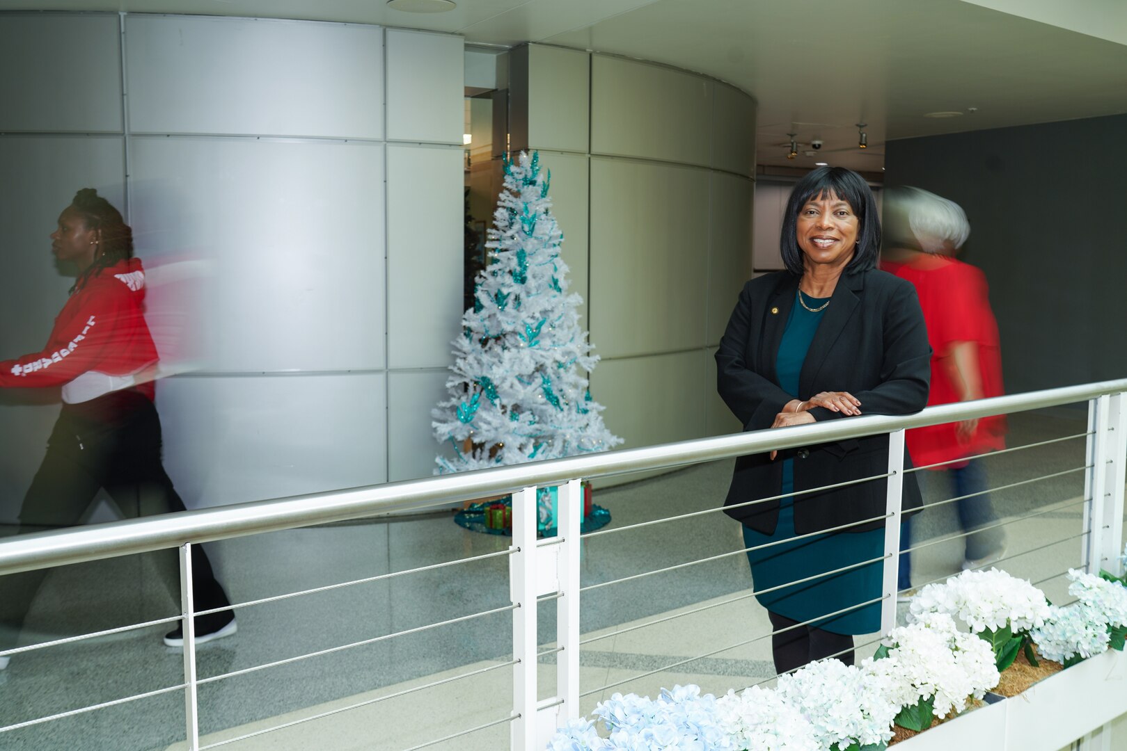 Woman standing at railing.