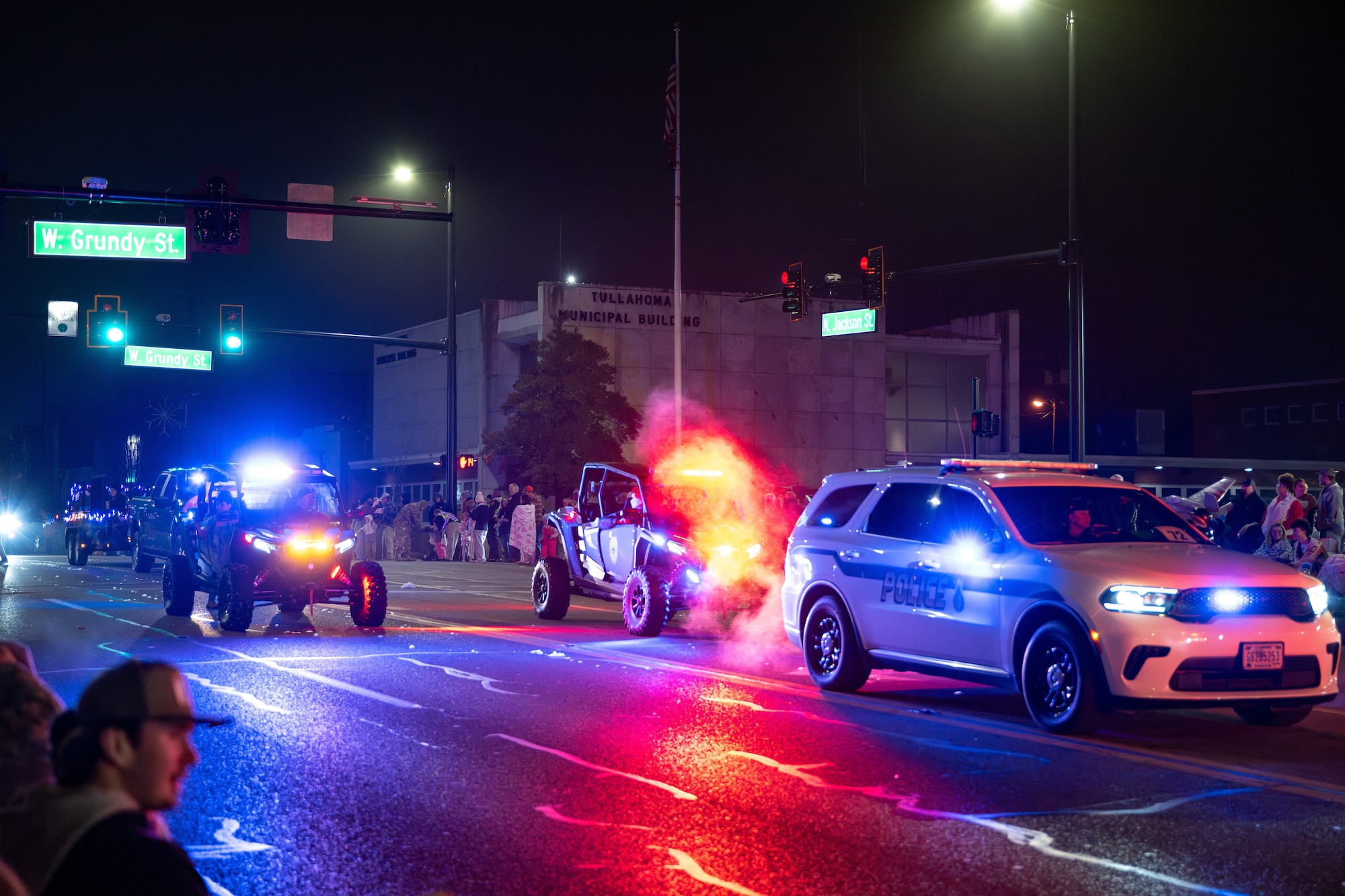 Members of the Arnold Air Force Base Security Forces team wave at attendees as they take part in the 69th annual Tullahoma Christmas Parade Dec. 5, 2025, in Tullahoma, Tenn. Members of the Security Forces team were joined by Arnold AFB Fire and Emergency Services and Arnold Engineering Development Complex leadership as they greeted paradegoers along the route. AEDC is headquartered at Arnold AFB. (U.S. Air Force photo by Brad Hicks)