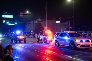Members of the Arnold Air Force Base Security Forces team wave at attendees as they take part in the 69th annual Tullahoma Christmas Parade Dec. 5, 2025, in Tullahoma, Tenn. Members of the Security Forces team were joined by Arnold AFB Fire and Emergency Services and Arnold Engineering Development Complex leadership as they greeted paradegoers along the route. AEDC is headquartered at Arnold AFB. (U.S. Air Force photo by Brad Hicks)
