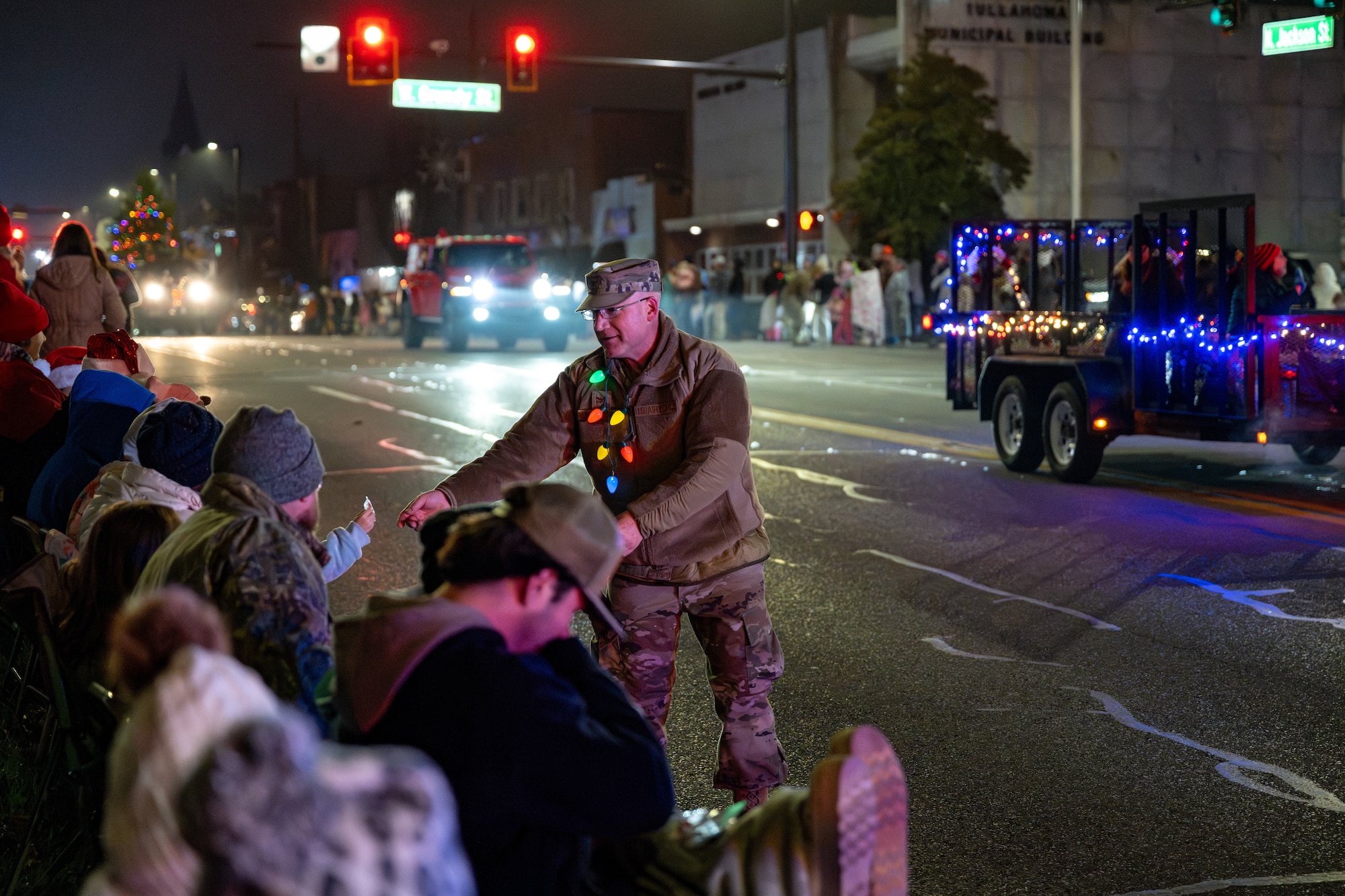 Arnold Engineering Development Complex Test Support Division Chief Col. Eric Withrow greets attendees and hands out treats during the 69th annual Tullahoma Christmas Parade Dec. 5, 2025, in Tullahoma, Tenn. Withrow and other AEDC leaders were joined by Arnold Air Force Base Fire and Emergency Services and Arnold AFB Security Forces as they greeted paradegoers along the route. AEDC is headquartered at Arnold AFB. (U.S. Air Force photo by Brad Hicks)