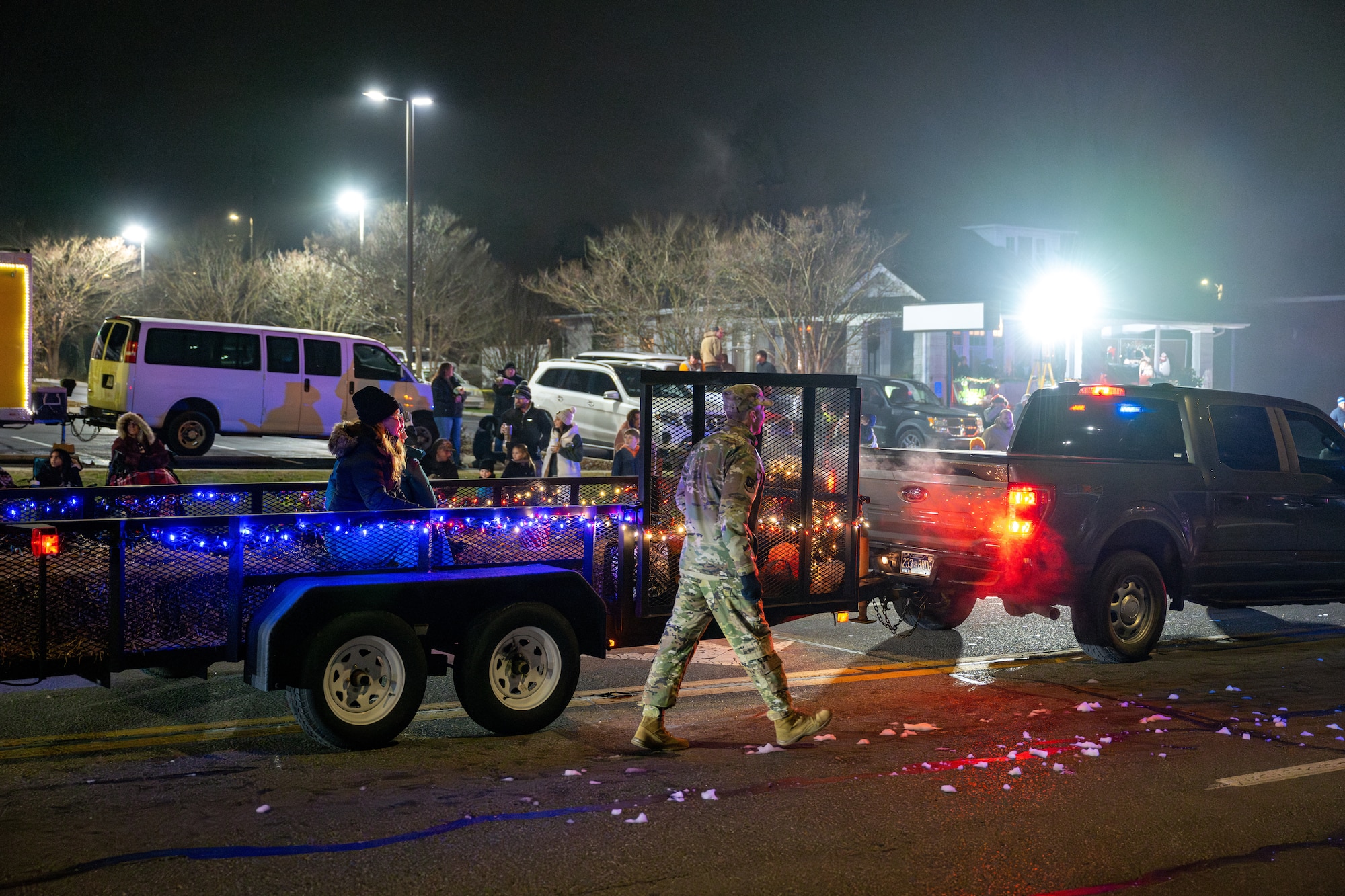 Arnold Engineering Development Complex Commander Col. Grant Mizell, after stopping to greet attendees, walks alongside one of the floats AEDC entered in the 69th annual Tullahoma Christmas Parade Dec. 5, 2025, in Tullahoma, Tenn. Mizell and other AEDC leaders were joined by Arnold Air Force Base Fire and Emergency Services and Arnold AFB Security Forces as they greeted paradegoers along the route. AEDC is headquartered at Arnold AFB. (U.S. Air Force photo by Brad Hicks)