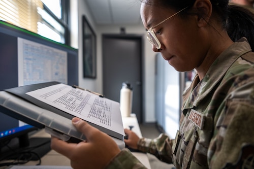 U.S. Air Force Airman 1st Class Summer Koszych, 6th Aircraft Maintenance Squadron debrief specialist, reads flight data at MacDill Air Force Base, Florida, Sept. 17, 2025. Debrief specialists are responsible for collecting, analyzing and communicating flight information between aircrew and maintenance personnel. On any given day, debrief members may contact up to 20 different agencies across the installation to ensure the most accurate, timely information  is communicated to stakeholders. (U.S. Air Force photo by Senior Airman Zachary Foster)