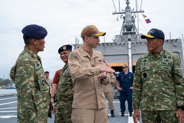 U.S. Navy Cmdr. Andrew Recame, center, commanding officer of Independence-variant littoral combat ship USS Cincinnati (LCS 20), speaks to Indonesian National Armed Forces Lieutenant General Tri Budi Utomo, right, Secretary General, Ministry of Defense, aboard Cincinnati during the Association of Southeast Asian Nations (ASEAN)-U.S. Maritime Exercise (AUMX) 2025, in Batam, Indonesia, Dec. 10, 2025. This is the second iteration of AUMX, designed to promote shared commitments to maritime partnerships, security, and stability in Southeast Asia.  (U.S. Navy photo by Mass Communication Specialist 2nd Class Anthony Robledo)