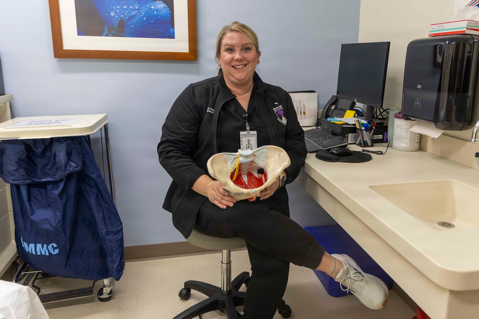 Dr. Kirby Smith, a pelvic health physical therapist in the Urogynecology Division, explains the different parts of the pelvic floor while holding an anatomical model at Walter Reed National Military Medical Center, Oct. 03, 2025. Pelvic floor therapists work with patients to address issues such as pelvic pain, incontinence and postpartum recovery through targeted exercises and techniques. (DOW photo by Roan Smith)