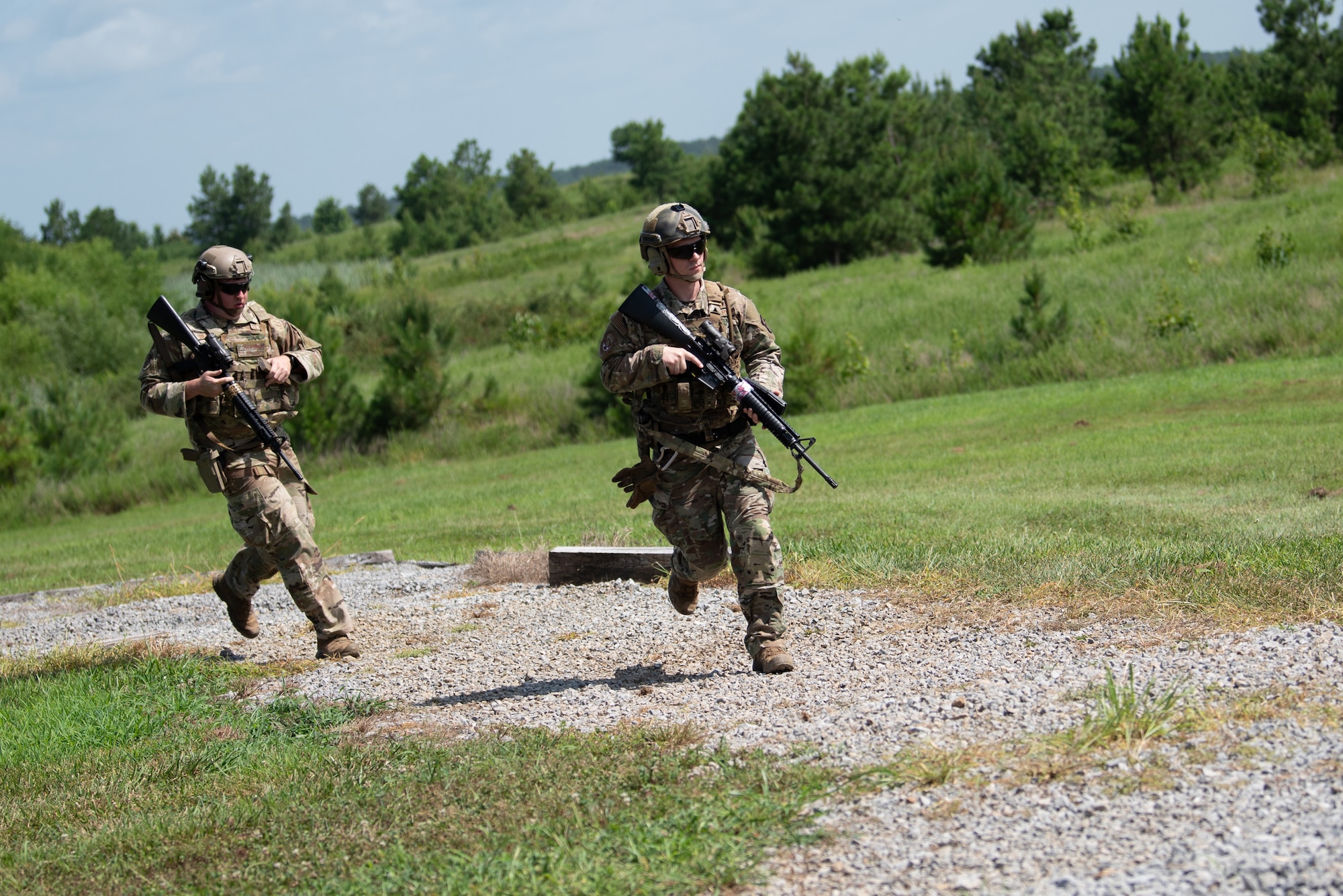 Tech. Sgt. Austin Goldman, left, from the Kentucky Air National Guard’s 123rd Contingency Response Group, and Tech. Sgt. Michael Bradley from the Kentucky Air Guard’s 123rd Special Tactics Squadron, sprint during a team challenge July 12, 2025, while competing in the Adjutant General’s Match, a marksmanship competition held at the Wendell H. Ford Regional Training center in Greenville, Ky. The event tested Soldiers and Airmen with realistic, combat-focused shooting scenarios designed to sharpen weapons proficiency and lethality. (U.S. Air National Guard photo by Airman 1st Class Angelee Barnett)