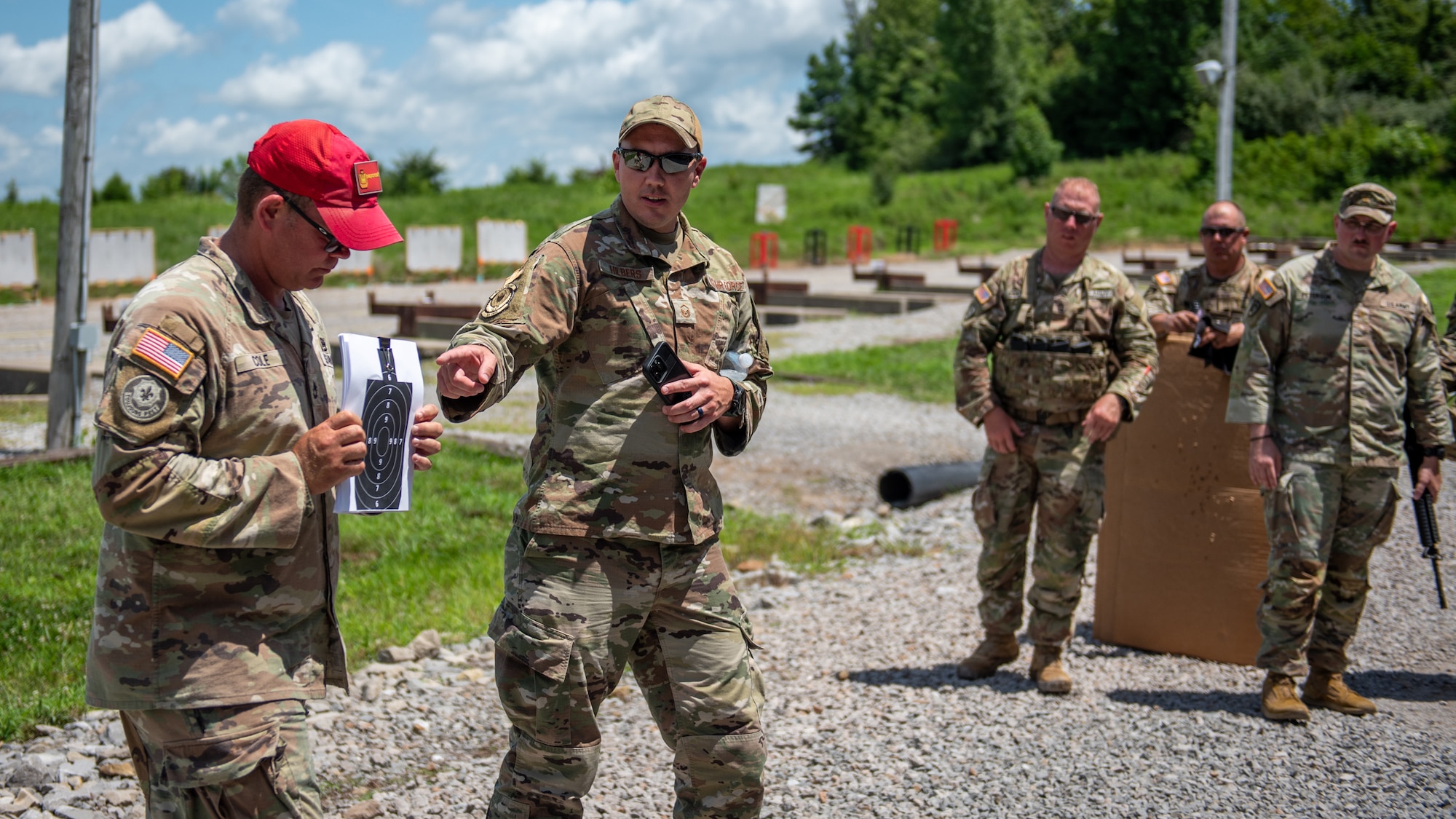 U.S. Air Force Master Sgt. Abrams Hilbers, center, of the Kentucky Air National Guard’s 123rd Contingency Response Group and U.S. Army Sgt. 1st Class Edward Cole, left, senior marksmanship coordinator for the Kentucky Army National Guard Small Arms Readiness Training Section, give instructions to competitors July 13, 2025, during the Adjutant General’s Match, a marksmanship competition held at the Wendell H. Ford Regional Training center in Greenville, Ky. The event tested Soldiers and Airmen with realistic, combat-focused shooting scenarios designed to sharpen weapons proficiency and lethality. (U.S. Air National Guard photo by Airman 1st Class Angelee Barnett)
