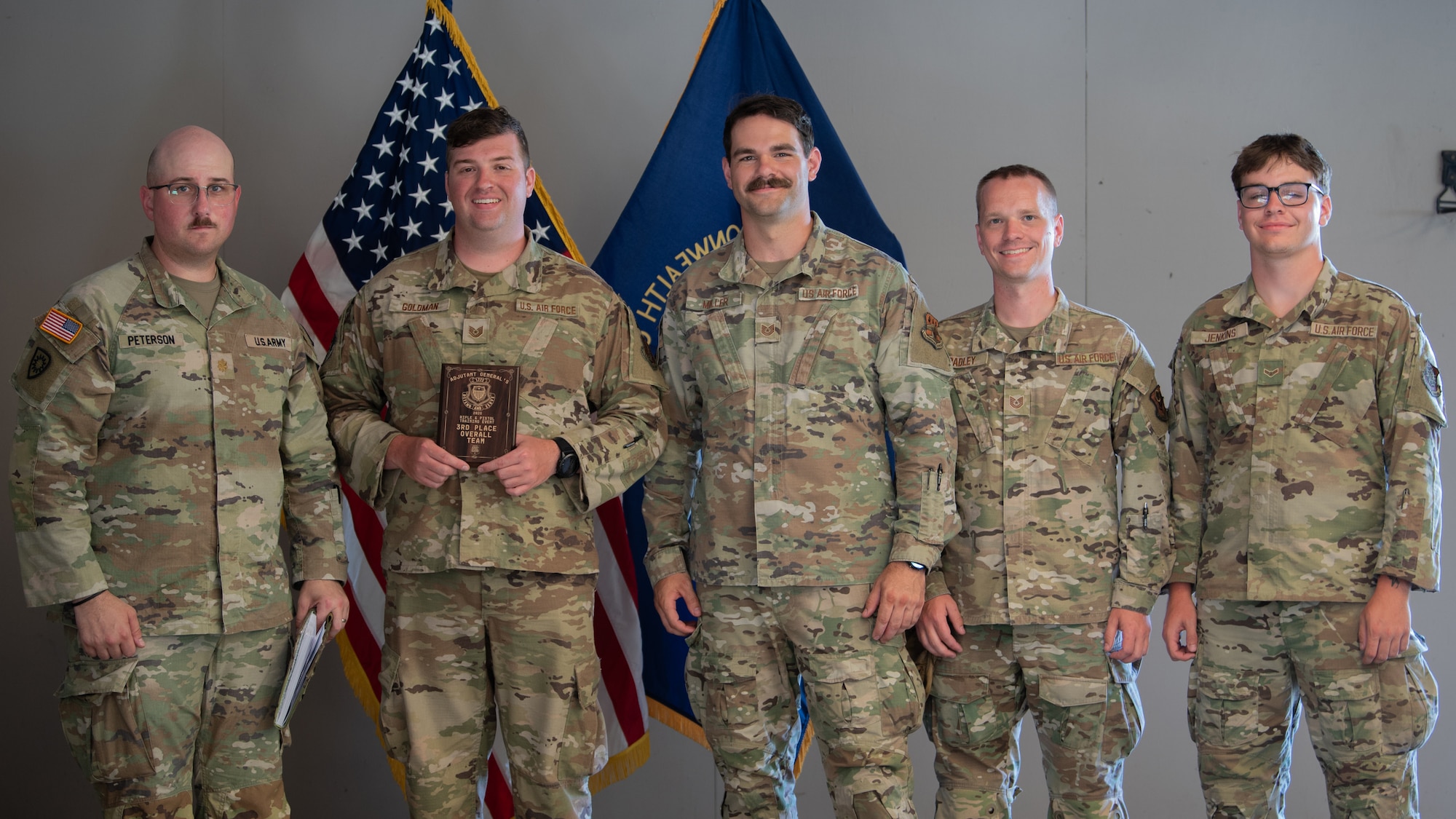 U.S. Army Maj. Christopher Peterson, left, state marksmanship coordinator for the Kentucky Army National Guard, presents the third-place overall award to members of the Kentucky Air National Guard Marksmanship Team July 13, 2025, at the conclusion of the Adjutant General’s Match, a marksmanship competition held at the Wendell H. Ford Regional Training center in Greenville, Ky. The event tested Soldiers and Airmen with realistic, combat-focused shooting scenarios designed to sharpen weapons proficiency and lethality. (U.S. Air National Guard photo by Airman 1st Class Angelee Barnett)