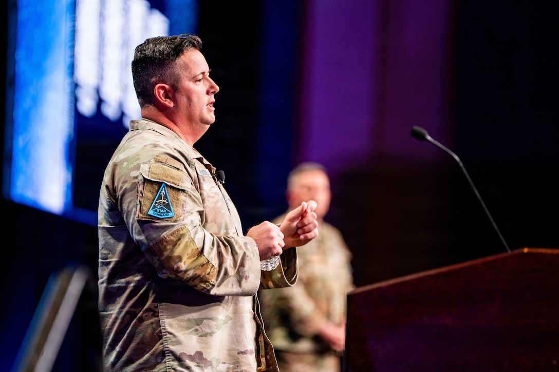 Space Force leader addressing speaking at a conference. They are on stage.