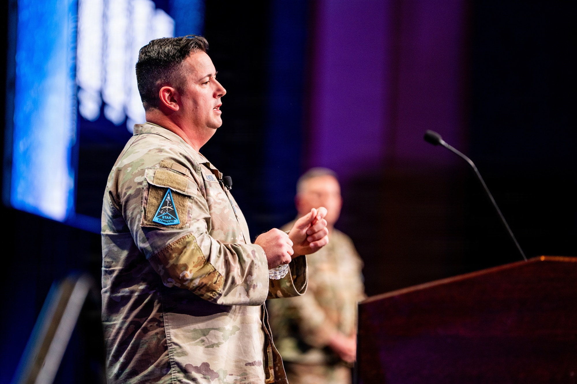 Space Force leader addressing speaking at a conference. They are on stage.