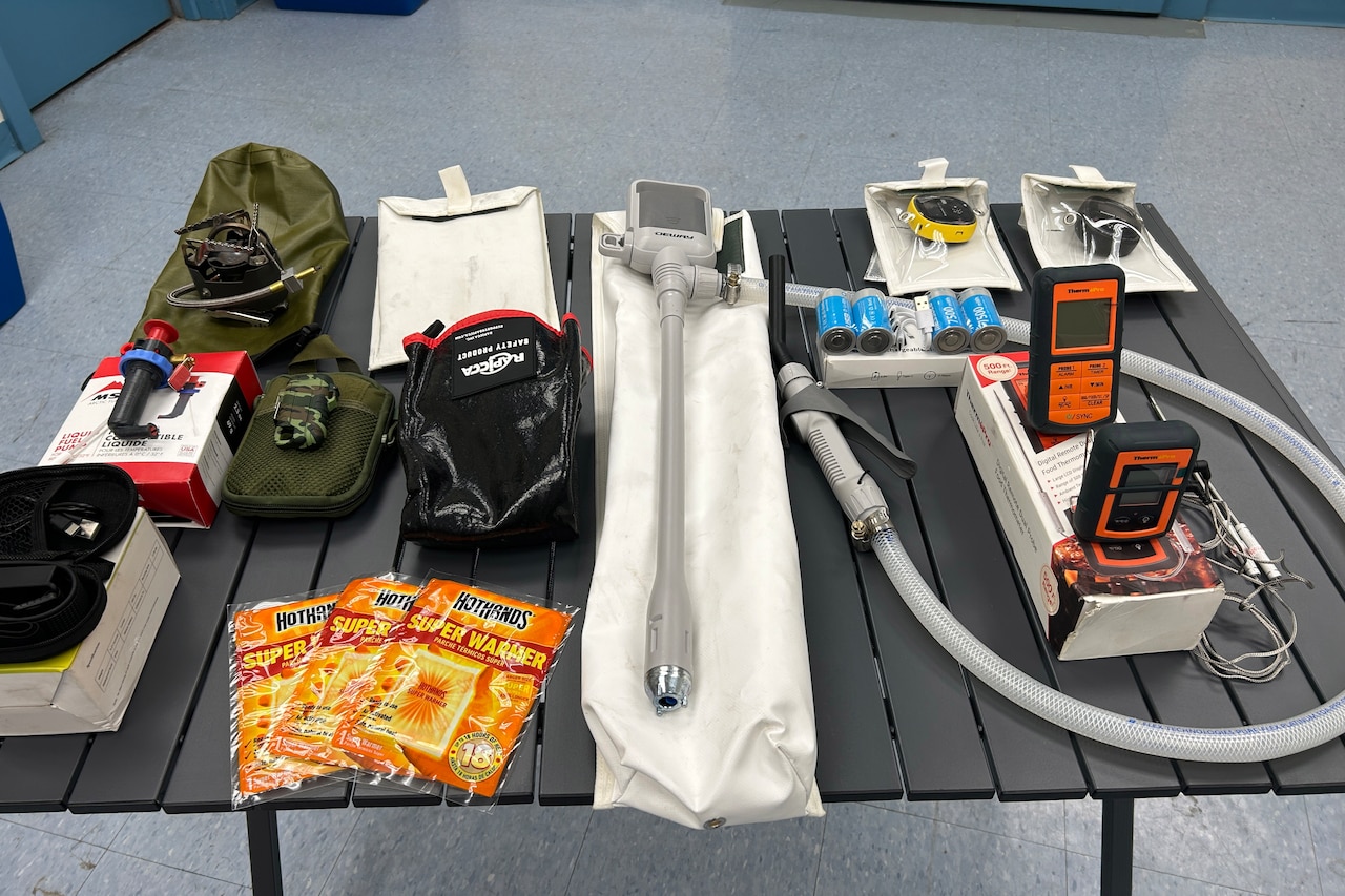 On a table sits several small apparatus and pieces of equipment.