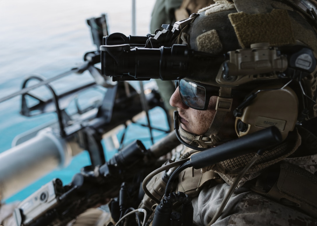U.S. Marine Corps Sgt. Logan Mitchell, a reconnaissance Marine with the Maritime Raid Force, 11th Marine Expeditionary Unit, rides in a UH-1Y Venom attached to Marine Medium Tiltrotor Squadron (VMM) 163 (Reinforced).