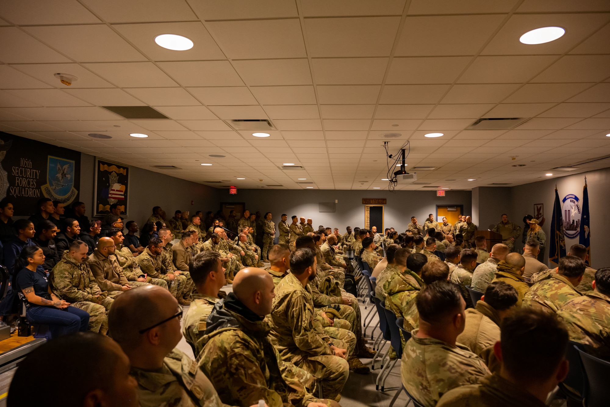 Three defenders carry flags in a ruck