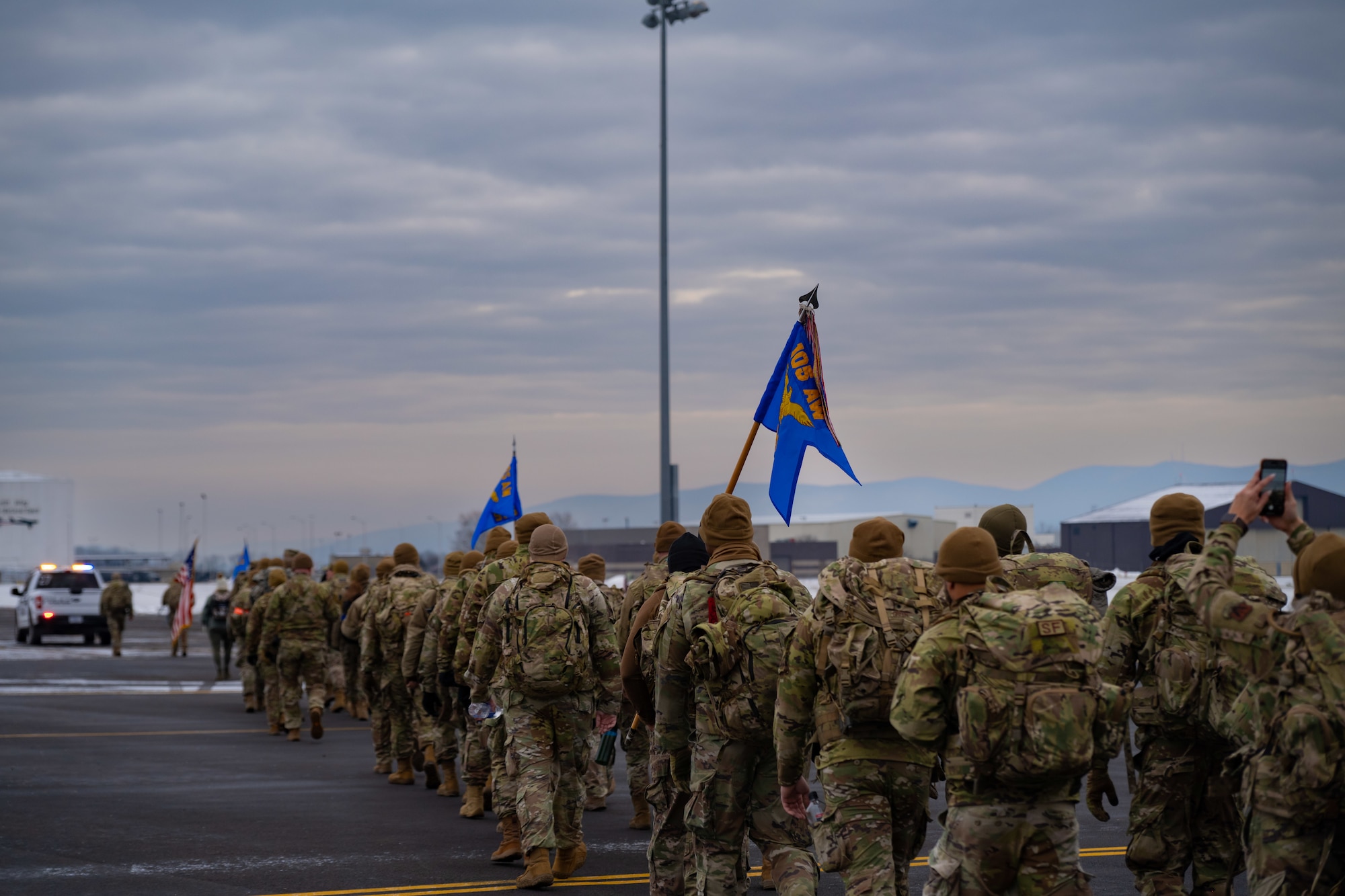 Three defenders carry flags in a ruck