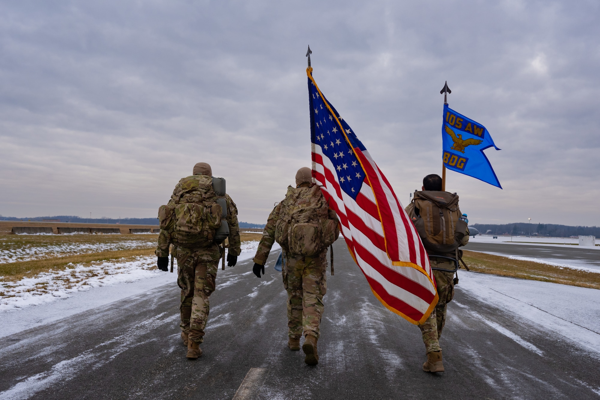 Three defenders carry flags in a ruck