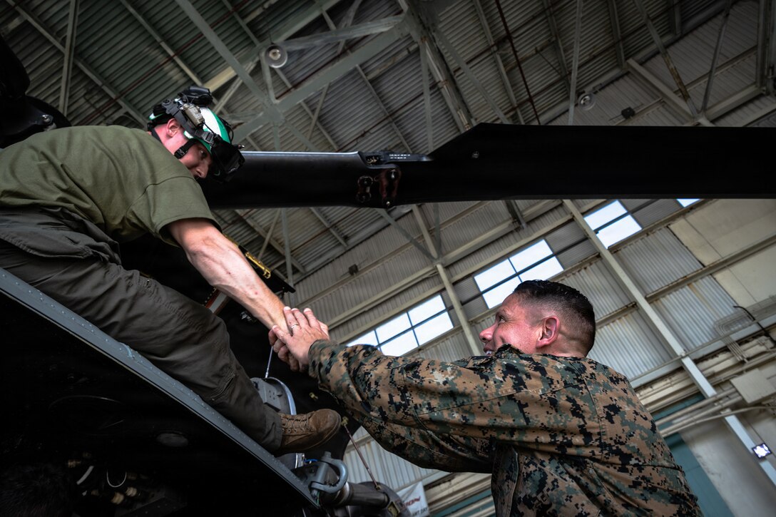 U.S. Marine Corps Sgt. Maj. Carlos A. Ruiz, the 20th Sergeant Major of the Marine Corps, greets a U.S. Marine Corps maintainer with Marine Medium Tiltrotor Squadron (VMM) 263, 22nd Marine Expeditionary Unit (Special Operations Capable), at Jose Aponte de la Torre Airport in Ceiba, Puerto Rico, Dec. 12, 2025. U.S. military forces are deployed to the Caribbean in support of the U.S. Southern Command mission, Department of War-directed operations, and the president’s priorities to disrupt illicit drug trafficking and protect the homeland. (U.S. Marine Corps photo)
