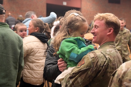 U.S Air Force Airman 1st Class Christopher Shannon holds his niece, Grace Shannon, after a homecoming ceremony Dec. 7, 2025, at the University of Cincinnati's Muntz Hall in Blue Ash, Ohio.