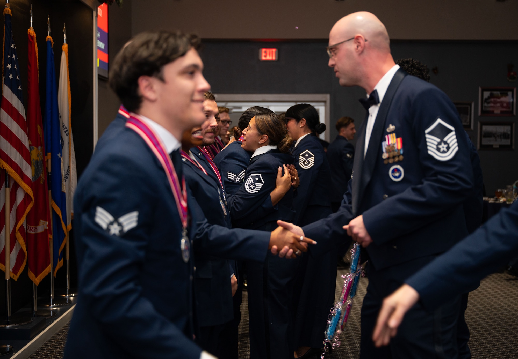 Service members, family, and friends congratulate the newest graduating class of Airman Leadership School.