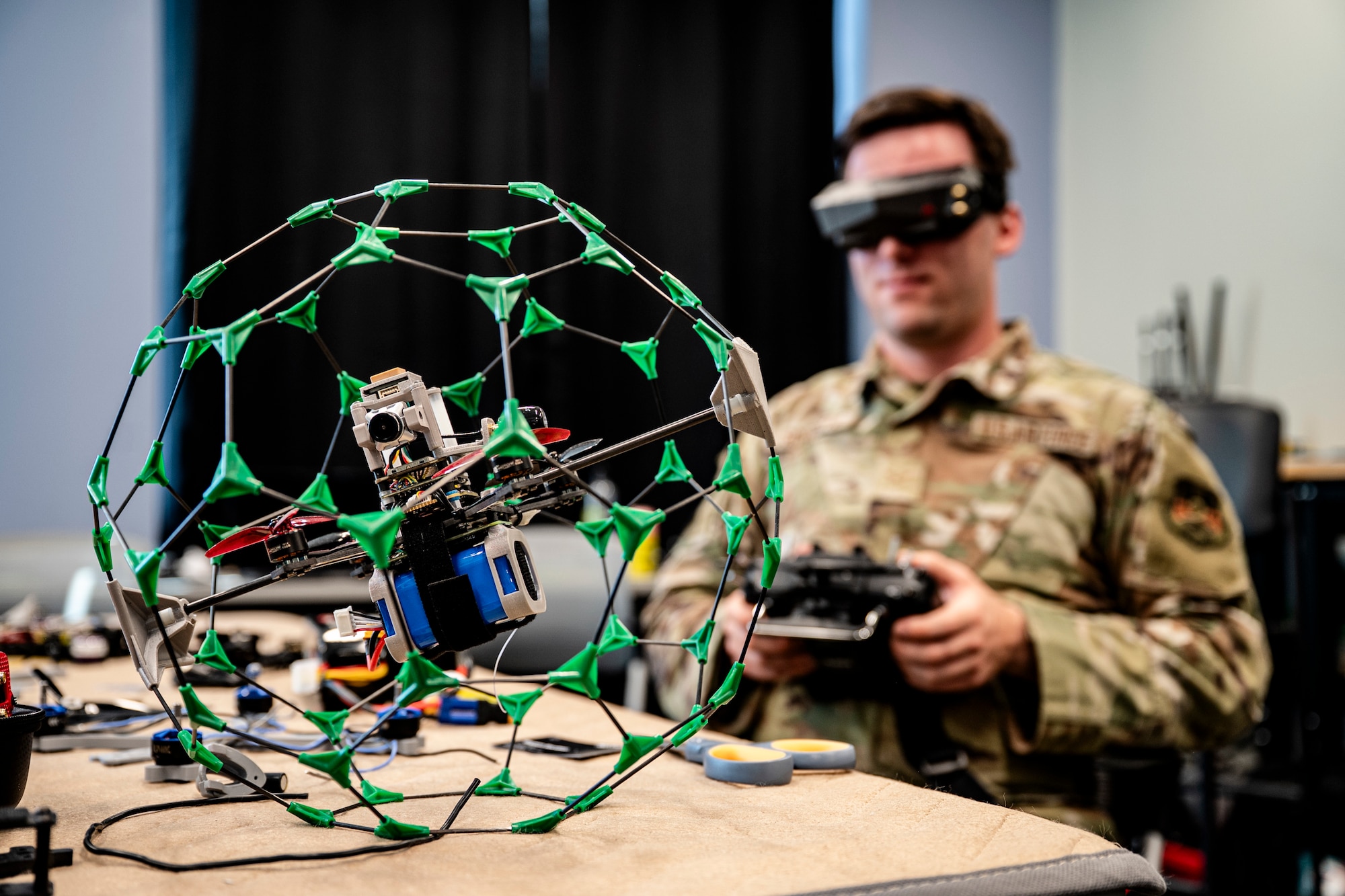 Person in military uniform holds a drone controller