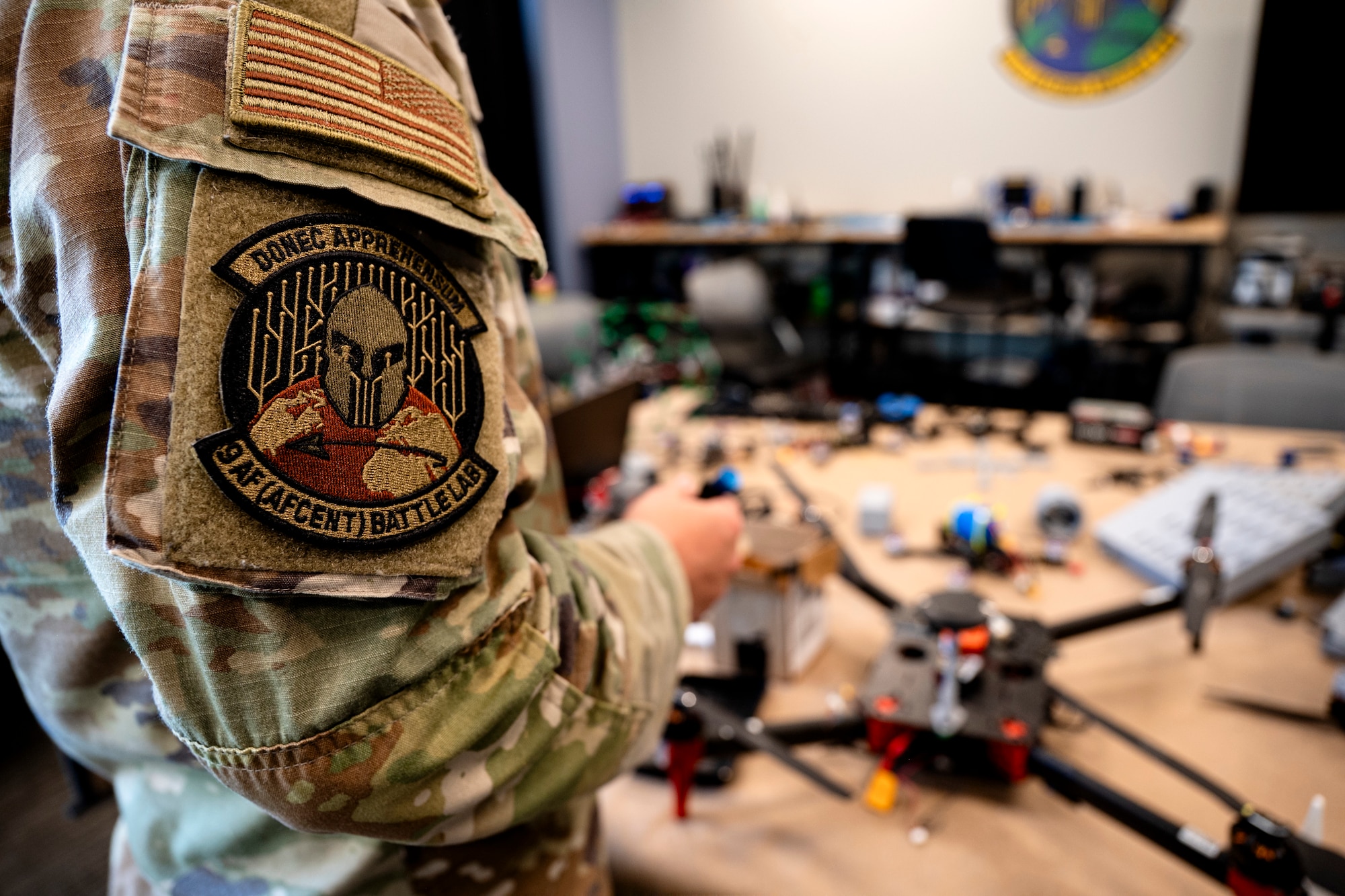 Person in military uniform assembles a drone