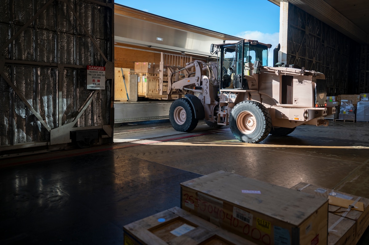 U.S. Air Force Senior Airman Matthew Cline, 13th Fighter Generation Squadron weapons loadcrew member, picks up cargo with a forklift at Misawa Air Base, Japan, Dec. 15, 2025. Misawa AB received F-35 Lightning II equipment in preparation for their arrival, supporting the 35th Fighter Wing’s ability to rapidly generate combat airpower. (U.S. Air Force photo by Senior Airman Brittany Russell)