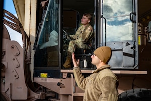 U.S. Air Force Tech. Sgt. Eric Danis, right, 13th Fighter Generation Squadron support section chief, guides Senior Airman Matthew Cline, 13th Fighter Generation Squadron weapons loadcrew member, as he loads cargo onto a forklift at Misawa Air Base, Japan, Dec. 15, 2025. Misawa AB received F-35 Lightning II equipment in preparation for their arrival, enhancing the 35th Fighter Wing’s ability to support forward-postured airpower and credible deterrence alongside allies and partners. (U.S. Air Force photo by Senior Airman Brittany Russell)