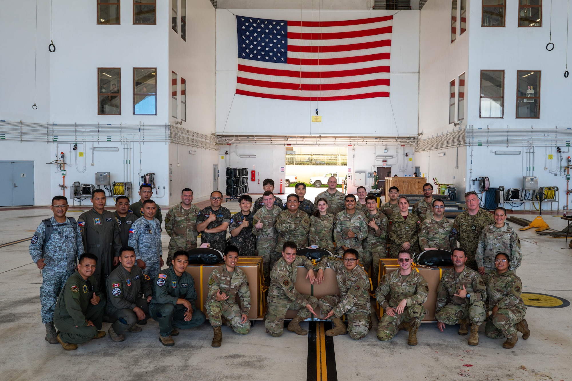 Members assigned to the 374th Air Expeditionary Wing combat mobility flight and partnering nation service members pose for a photo.